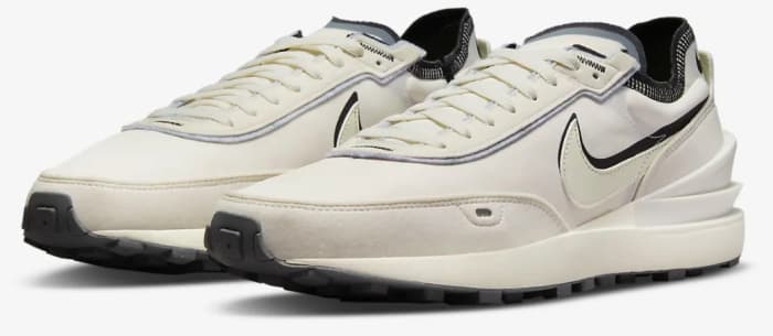 View of tan and black Nike shoes.